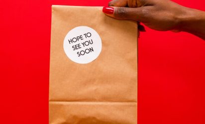a person holding a paper bag